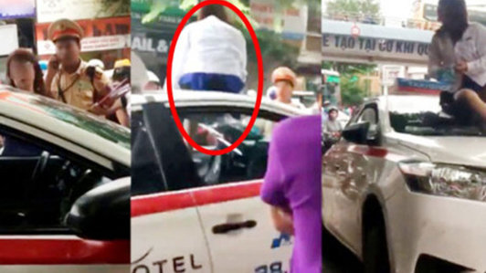 Vượt đèn đỏ bị CSGT yêu cầu dừng xe, nữ tài xế trèo lên nóc xe ăn vạ